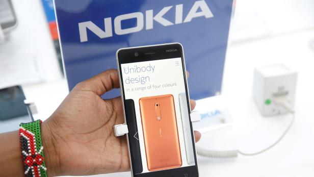 FILE PHOTO: A sales representative displays a Nokia 5 smartphone at a shop in Nairobi