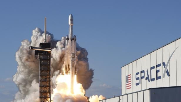A SpaceX Falcon Heavy rocket, carrying the Arabsat 6A communications satellite, lifts off from the Kennedy Space Center