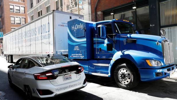 A Toyota Project Portal hydrogen fuel cell electric semi-truck and a Honda Clarity hydrogen fuel cell vehicle are shown during an event in San Francisco, California