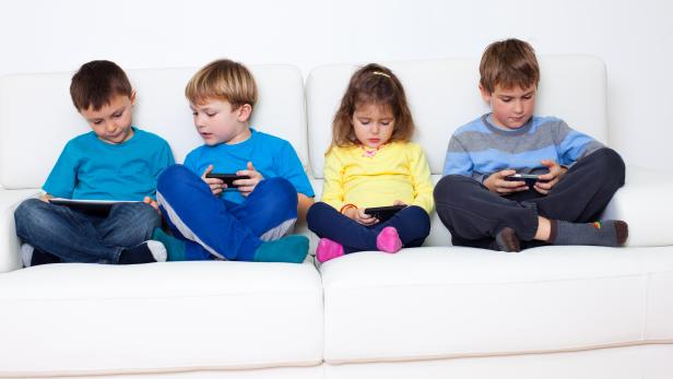 Children playing games on cellphones