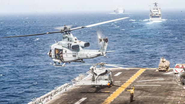 A UH-1Y Venom helicopter with Marine Medium Tiltrotor Squadron (VMM) 163 (Reinforced), 11th Marine Expeditionary Unit (MEU), takes off from the flight deck of the amphibious assault ship USS Boxer (LHD 4) during its transit through Strait of Hormuz