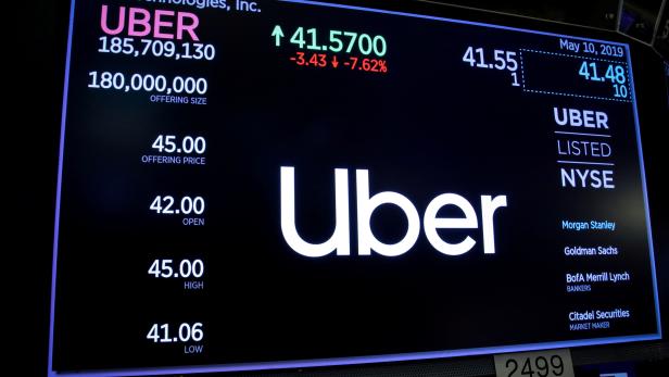 FILE PHOTO: A screen displays the company logo and the trading information for Uber Technologies Inc. after the closing bell on the day of it's IPO at the NYSE in New York