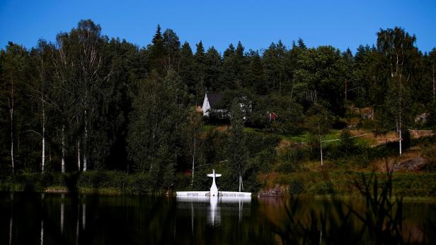 Norway's first battery-powered aircraft piloted by Avinor Chief Executive Dag Falk-Petersen is seen partly submerged in a lake after crash-landing, in Nornestjonn, Arendal
