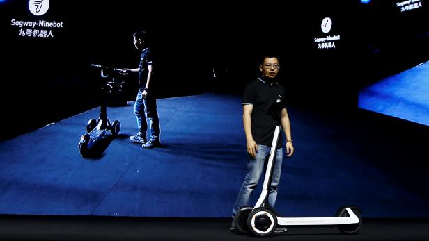 Ninebot President Wang Ye unveils semi-autonomous scooter KickScooter T60 that can return itself to charging stations without a driver, at a Segway-Ninebot product launch event in Beijing