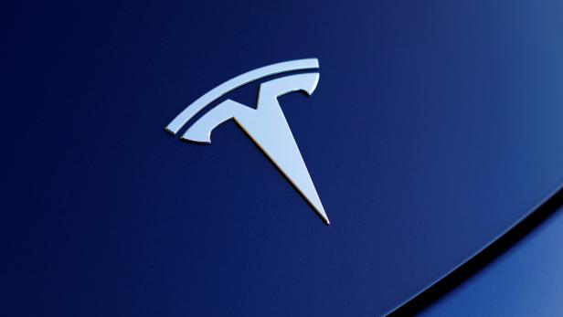 FILE PHOTO: The front hood logo on a 2018 Tesla Model 3 electric vehicle is shown in Cardiff, California