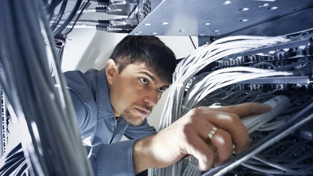 Technician engeneer is checking server's wires in data center