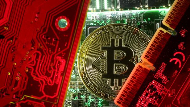 FILE PHOTO: FILE PHOTO: A copy of bitcoin standing on PC motherboard is seen in this illustration picture