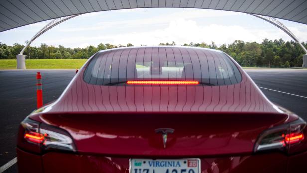 FILE PHOTO: IIHS media relations associate Young demonstrates a front crash prevention test on a Tesla Model 3 at IIHS-HLDI Vehicle Research Center in Ruckersville, Virginia