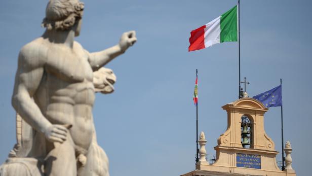FILE PHOTO: The Italian flag waves over the Quirinal Palace in Rome