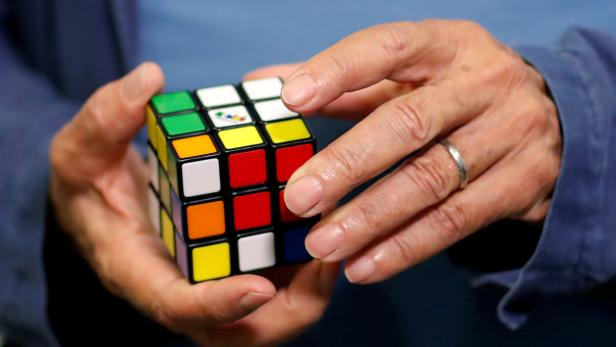 FILE PHOTO: Rubik solves a Rubik's cube as he poses during the world's largest Rubik's Cube championship in Aubervilliers