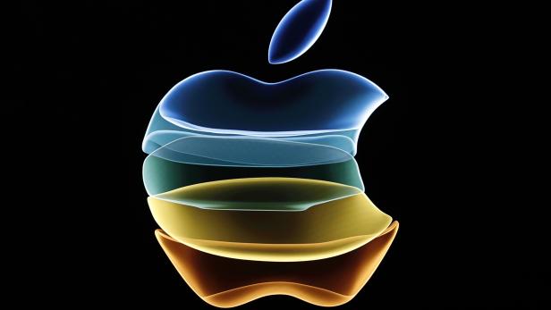 The Apple logo is displayed at an event at their headquarters in Cupertino