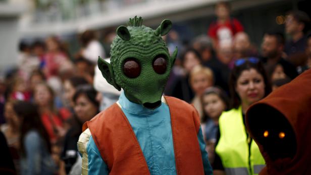 A member of the 501st Legion Spanish Garrison dress up as "Greedo" from the movie "Star Wars" during a solidarity parade to spread the message of bone marrow donation and the fight against cancer in Malaga 