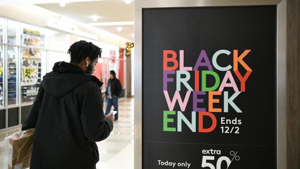 Holiday shoppers look for deals during the Black Friday sales event at the Pentagon Centre shopping mall in Arlington