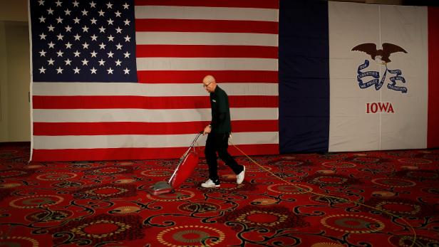 Worker Joe Robinson vacuums at the site of Democratic U.S. presidential candidate Senator Bernie Sanders' Caucus night rally in Des Moines