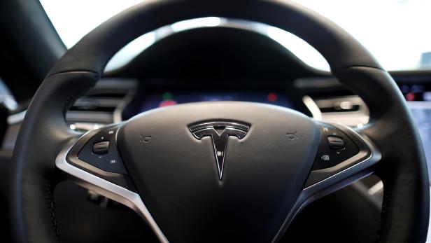 FILE PHOTO: The logo of Tesla is seen on a steering wheel of its Model S electric car at its dealership in Seoul