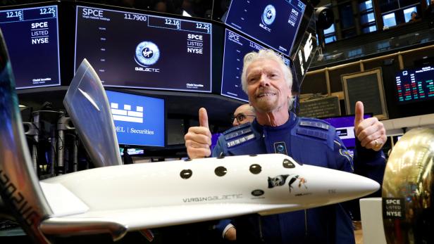 FILE PHOTO: Sir Richard Branson poses on floor of New York Stock Exchange (NYSE) ahead of Virgin Galactic (SPCE) trading in New York