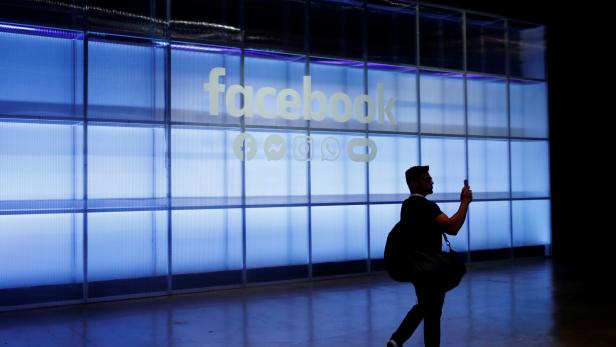 FILE PHOTO: An attendee takes a photograph of a sign during Facebook Inc's F8 developers conference in San Jose
