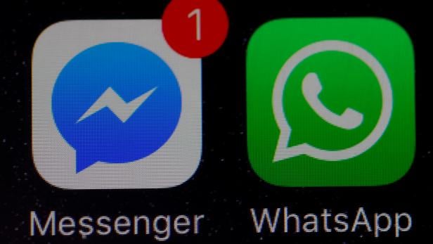 FILE PHOTO: WhatsApp and Facebook messenger icons are seen on an iPhone in Manchester , Britain.