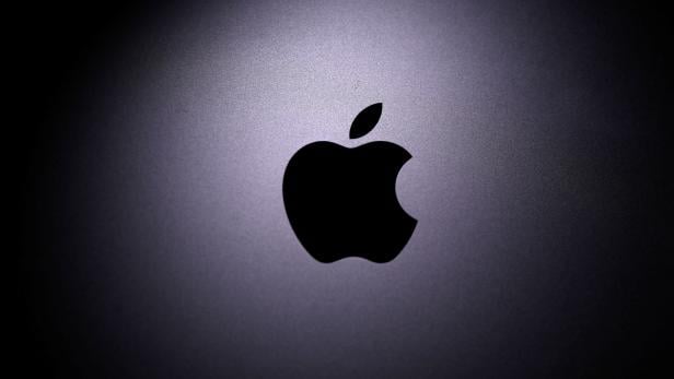 Apple logo is seen on the Macbook in this illustration taken