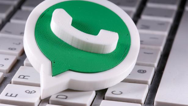 A 3D printed Whatsapp logo is placed on the keyboard in this illustration taken