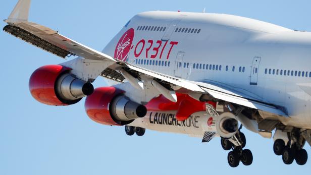Richard Branson's Virgin Orbit, with a rocket underneath the wing of a modified Boeing 747 jetliner, takes off to for a key drop test of its high-altitude launch system for satellites from Mojave, California