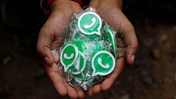 FILE PHOTO: A WhatsApp-Reliance Jio representative displays keychains with the logo of WhatsApp for distribution during a drive by the two companies to educate users, on the outskirts of Kolkata