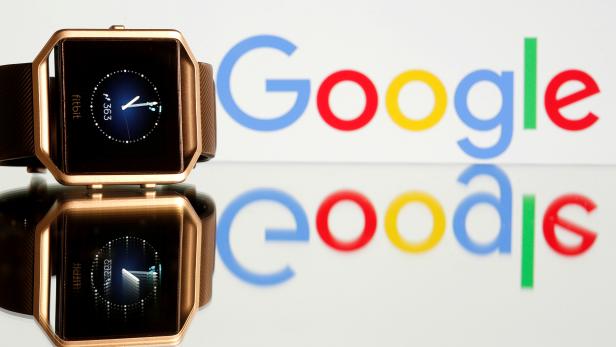 FILE PHOTO: FILE PHOTO: Fitbit Blaze watch is seen in front of a displayed Google logo in this illustration