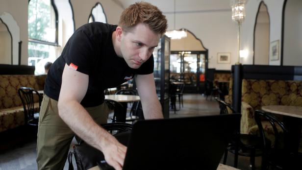 FILE PHOTO: Austrian lawyer and privacy activist Schrems prepares his laptop during a Reuters interview in Vienna