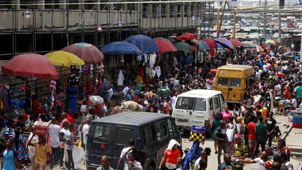 People shop at a market in Lagos