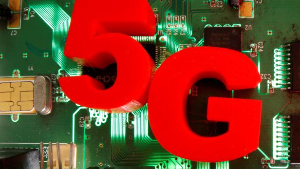 FILE PHOTO: 3D-printed objects representing 5G are put on a motherboard in this picture illustration