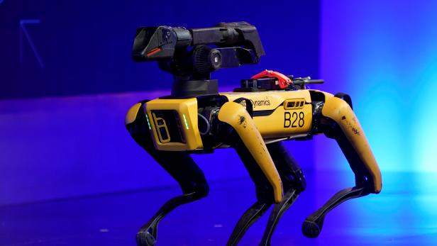A robot from Boston Dynamics walks around the stage at the WSJTECH live conference in Laguna Beach, California