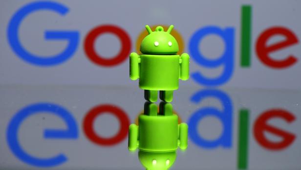 FILE PHOTO: A 3D printed Android mascot in front of a Google logo in this illustration