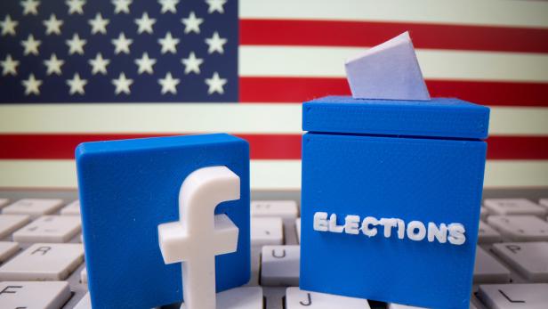 FILE PHOTO: A 3D-printed elections box and Facebook logo are placed on a keyboard in front of U.S. flag in this illustration