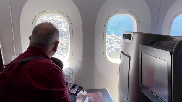 Passengers look out of a plane window during Qantas Great Southern Land scenic flight in Australia