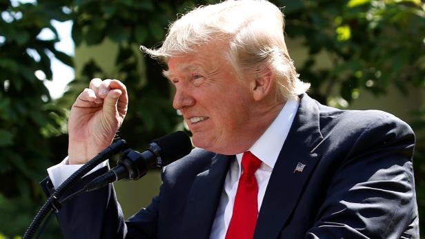 FILE PHOTO: U.S. President Trump refers to temperature change as he announces decision to withdraw from Paris Climate Agreement at White House in Washington
