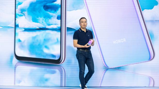 President of Huawei's Honor brand George Zhao displays Honor 20 Pro smartphone with a new colour variant at a launch event in Xian, Shaanxi