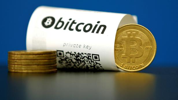 FILE PHOTO: An illustration photo shows a Bitcoin (virtual currency) paper wallet with QR codes and a coin are seen at La Maison du Bitcoin in Paris