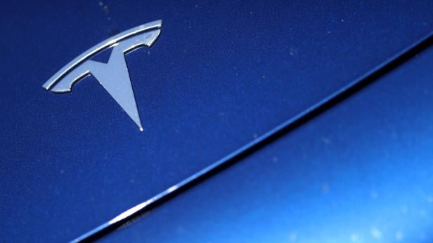 FILE PHOTO: The Tesla logo is seen on a car in Los Angeles