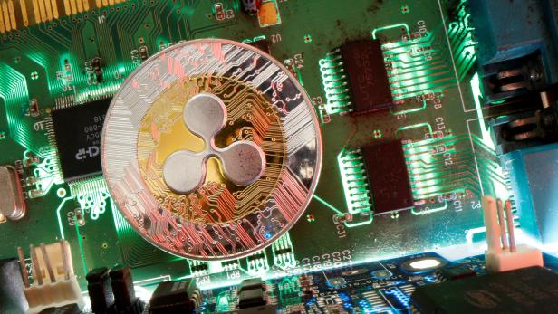 Representation of the virtual currency Ripple coin is seen on a motherboard in this picture illustration