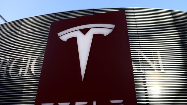 FILE PHOTO: Logo of electric vehicle maker Tesla is seen near a shopping complex in Beijing