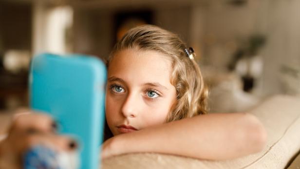 Teenage girl using social media on phone