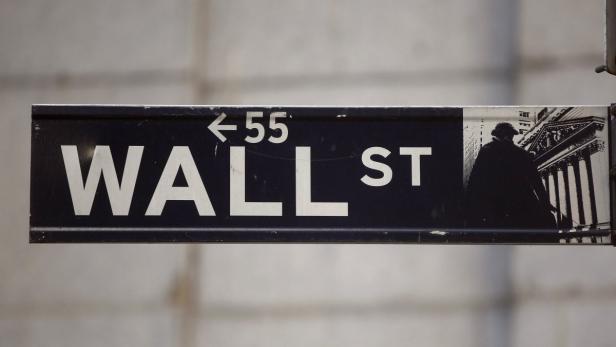 The Wall Street sign is seen near the New York Stock Exchange, November 19, 2012. REUTERS/Chip East (UNITED STATES - Tags: BUSINESS)