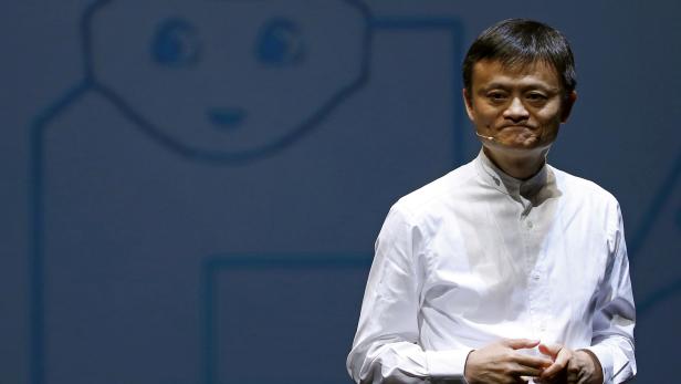 FILE PHOTO: Jack Ma, founder and executive chairman of China's Alibaba Group, speaks in front of a picture of SoftBank's human-like robot named 'pepper' during a news conference in Chiba