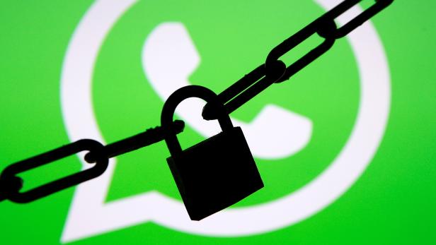 FILE PHOTO: A photo illustration shows a chain and a padlock in front of a displayed Whatsapp logo