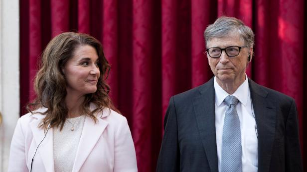 FILE PHOTO: Philanthropist and co-founder of Microsoft, Bill Gates and his wife Melinda listen to the speech by French President Francois Hollande, prior to being awarded Commanders of the Legion of Honor at the Elysee Palace in Paris