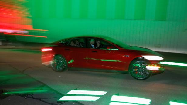 FILE PHOTO: People test drive the new all-wheel-drive version of the Tesla Model S car in Hawthorne
