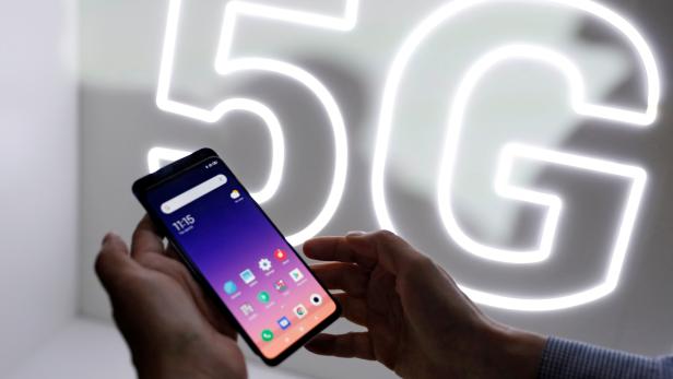 FILE PHOTO: Person checks out the new Xiaomi Mi 9 mobile phone ahead of the Mobile World Congress (MWC 19) in Barcelona