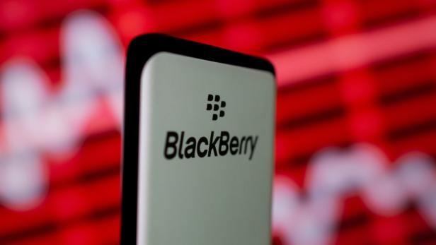 The Blackberry logo is seen on a smartphone in front of a displayed stock graph in this illustration