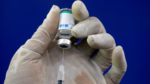 FILE PHOTO: A paramedic prepares a dose of the coronavirus disease (COVID-19) vaccine before administering it to a resident, at a vaccination center in Karachi,
