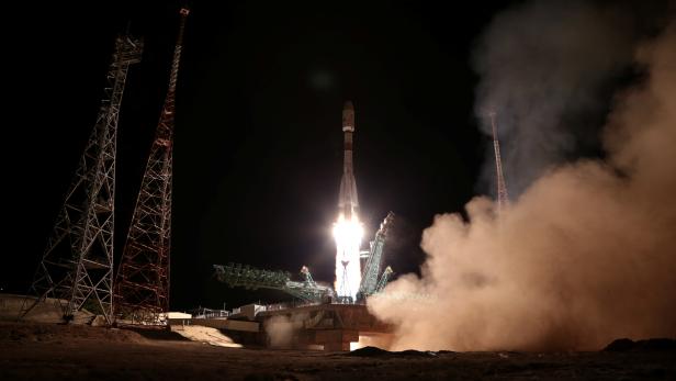 A rocket booster with satellites of British firm OneWeb blasts off from a launchpad at the Baikonur Cosmodrome